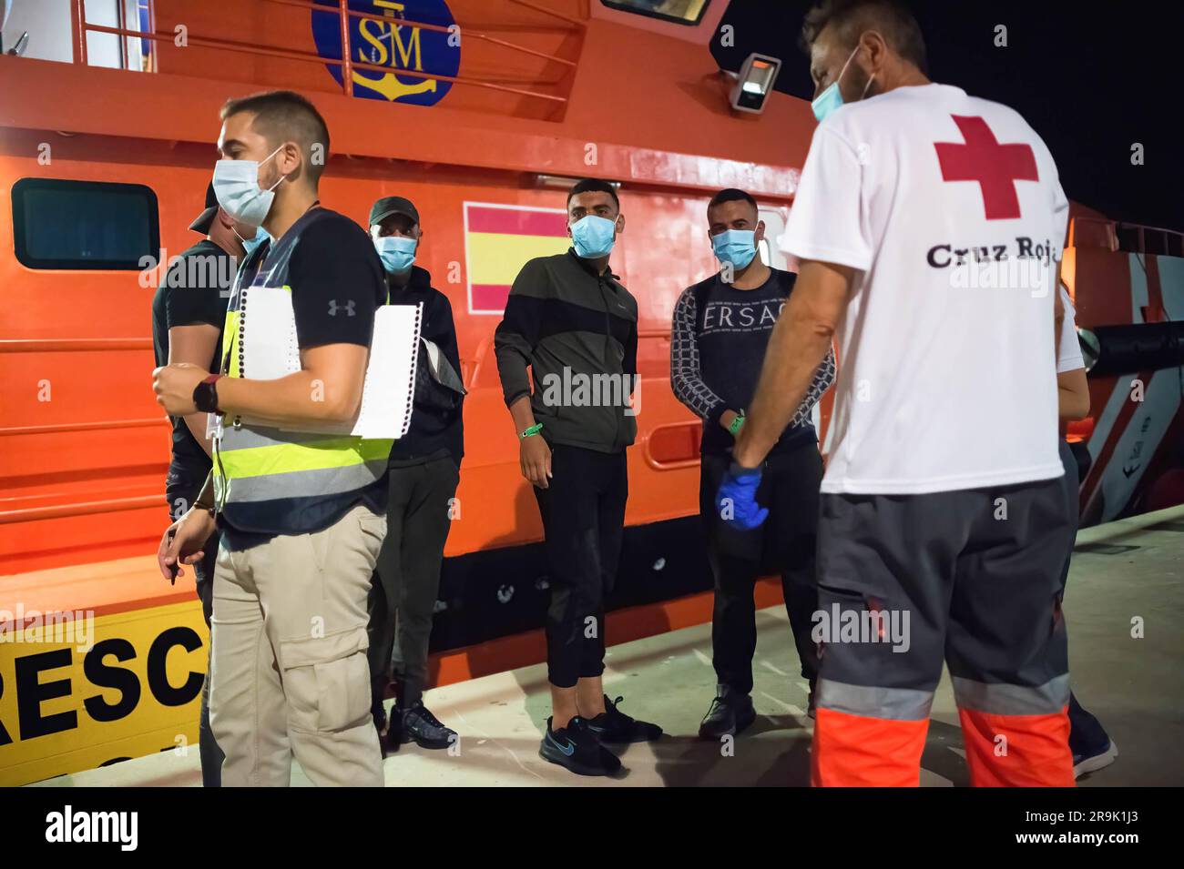 Migrants, who were rescued from a dinghy at the Mediterranean Sea, are ...