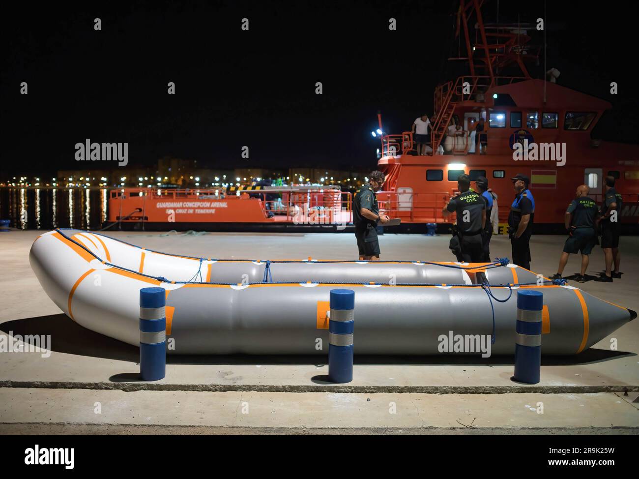 A dinghy used by migrants is seen in front of a rescue vessel after ...