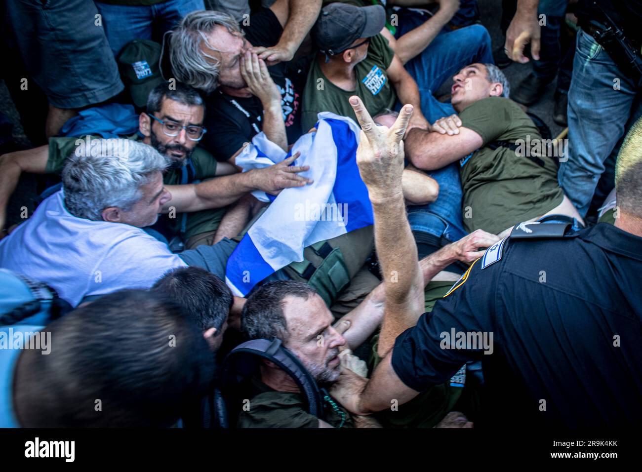 Modiin, Israel. 27th June, 2023. Israeli police officers try to remove Protestors blocking the road during a protest outside Minister of Justice Yariv Levin's home. Hundreds of protesters against the government's judicial overhaul staged a fiery demonstration outside Justice Minister Yariv Levin's home, as they vowed to ramp up protests over the advancement of a bill to curb the High Court of Justice's power to review government decisions. (Photo by Eyal Warshavsky/SOPA Images/Sipa USA) Credit: Sipa USA/Alamy Live News Stock Photo