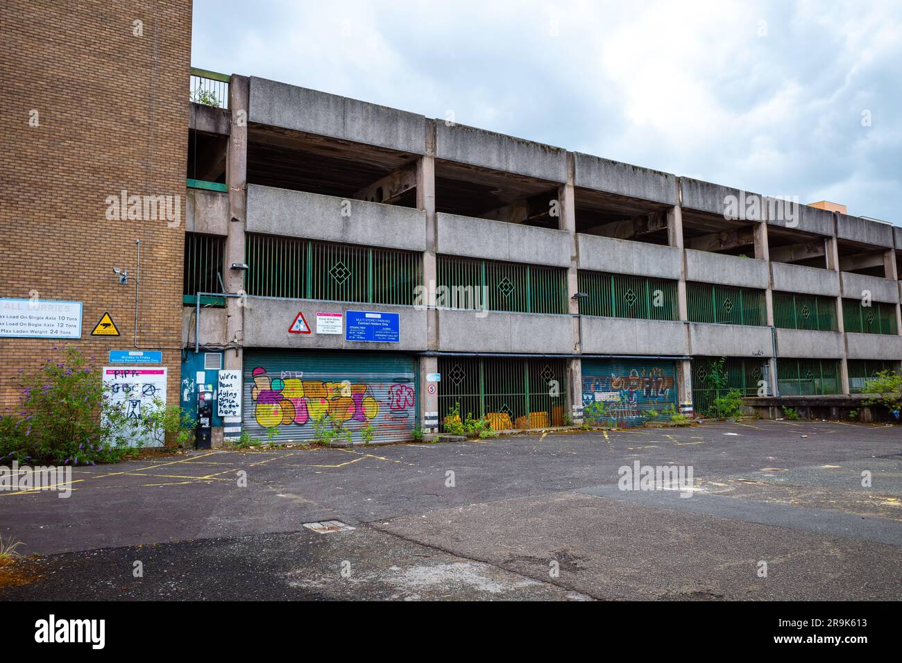 Decaying urban architecture with graffiti, neglected and closed car