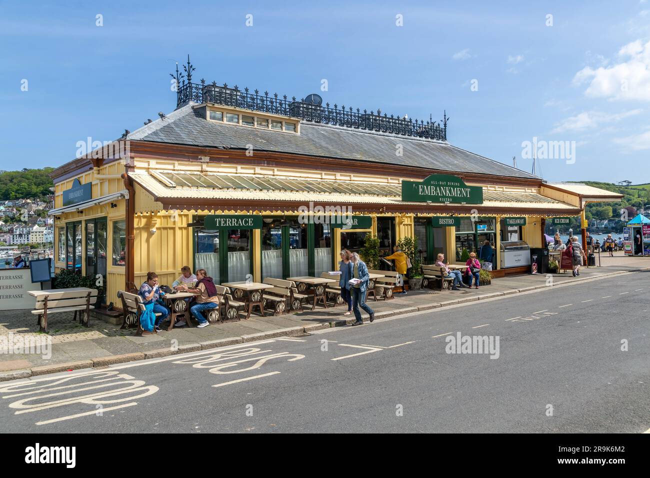 People sitting outside Embankment cafe bistro, Dartmouth, Devon, England, UK formerly the Station restaurant Stock Photo