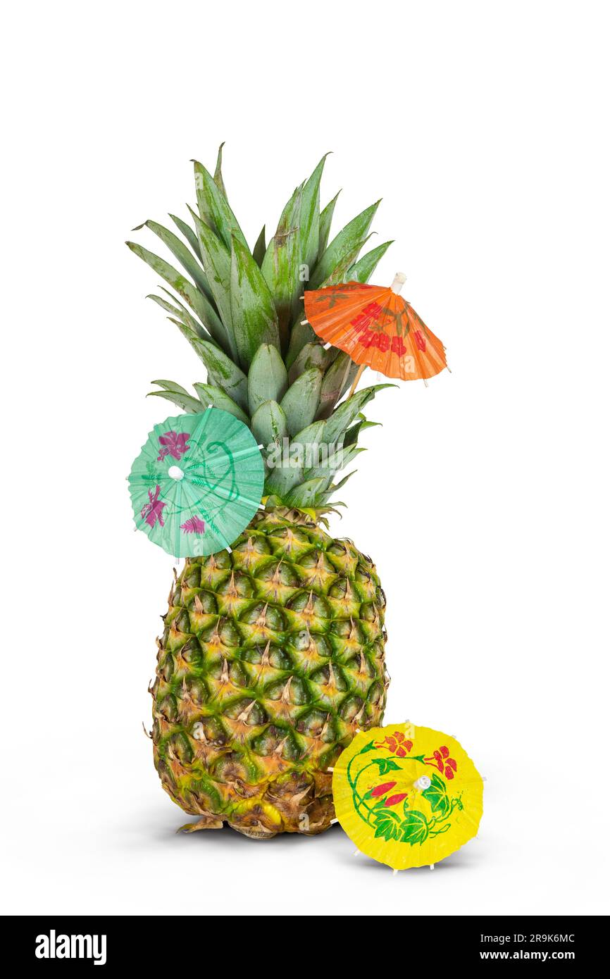 Pineapple with cocktail umbrellas isolated on white background. Stock Photo
