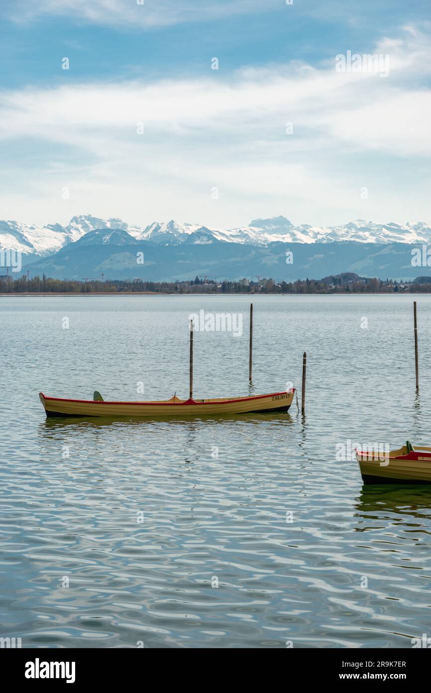 Pfaeffikon, Canton Zurich, Switzerland, April 10, 2023 Little boats are drifting on the surface of the lake Pfaeffikersee Stock Photo