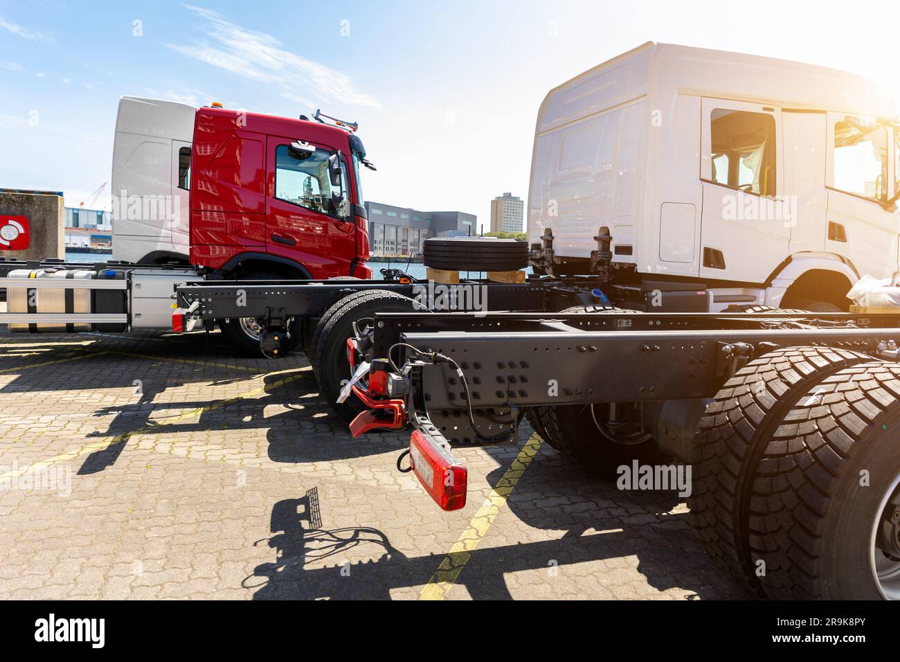 Back view many new heavy commercial cargo transport vehicles stand at