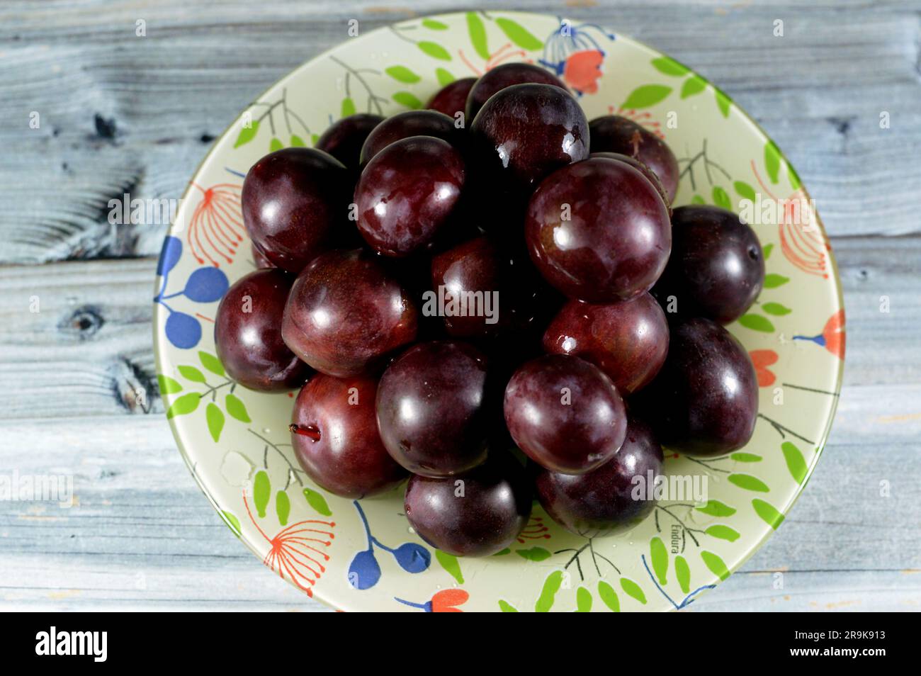 pile of plum fruit, A fruit of some species in Prunus subg. Prunus