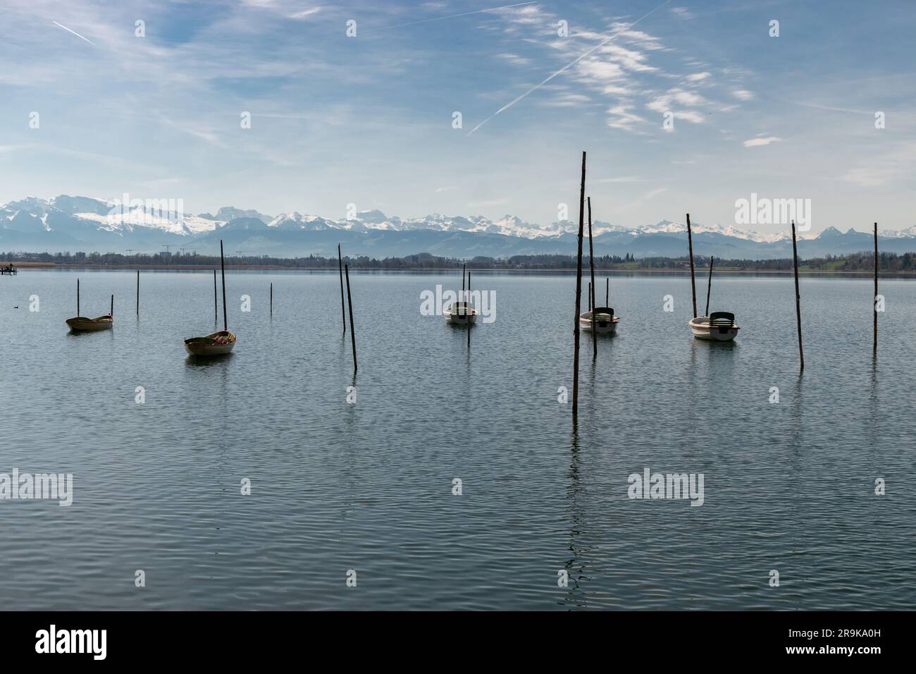 Pfaeffikon, Canton Zurich, Switzerland, April 10, 2023 Little boats are drifting on the surface of the lake Pfaeffikersee Stock Photo