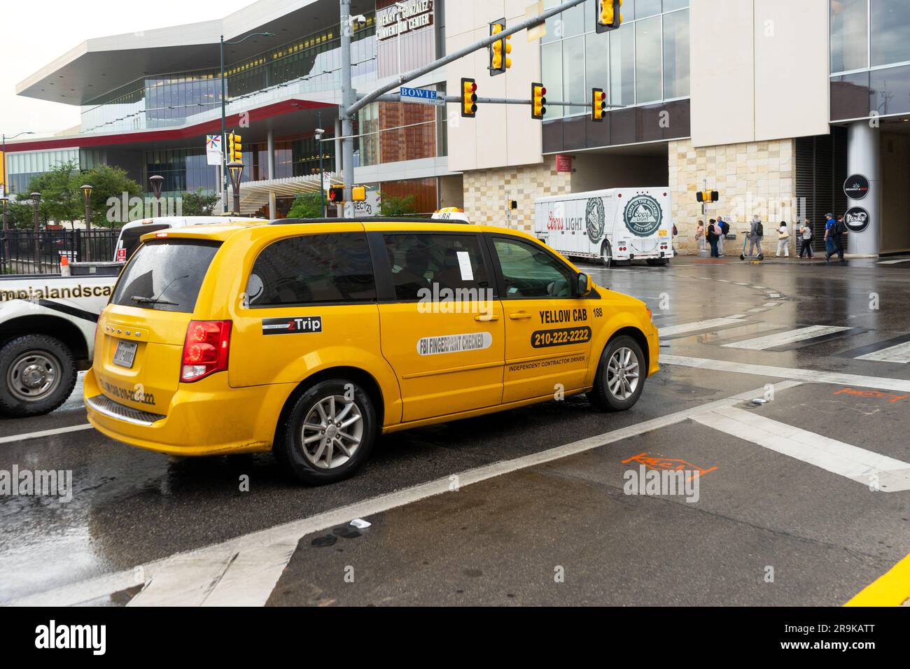 San Antonio, Texas, USA – May 9, 2023: Dodge minivan Yellow Cab Taxis on Bowie Street in San Antonio, Texas. Stock Photo