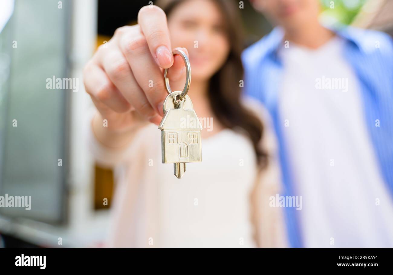 Couple of husband and wife holding key of new house, People spending