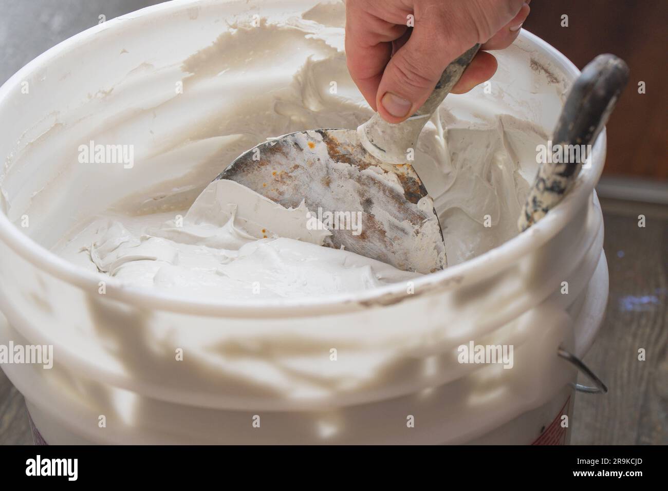 Working with sparkle wall compound spatula human hand construction