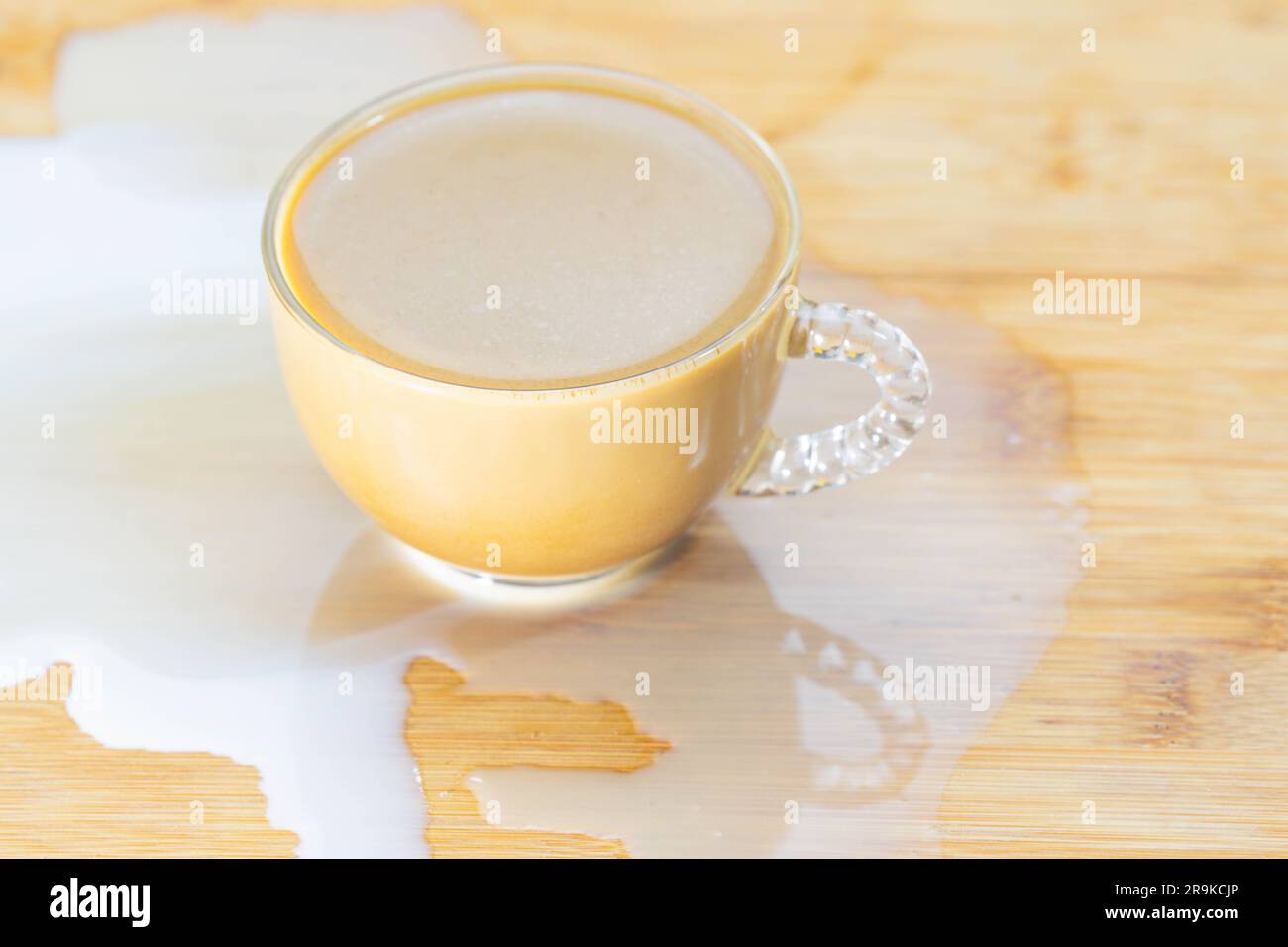 Spilled milc coffee cup studio shot, top down perspective, copy space, disaster theme Stock Photo