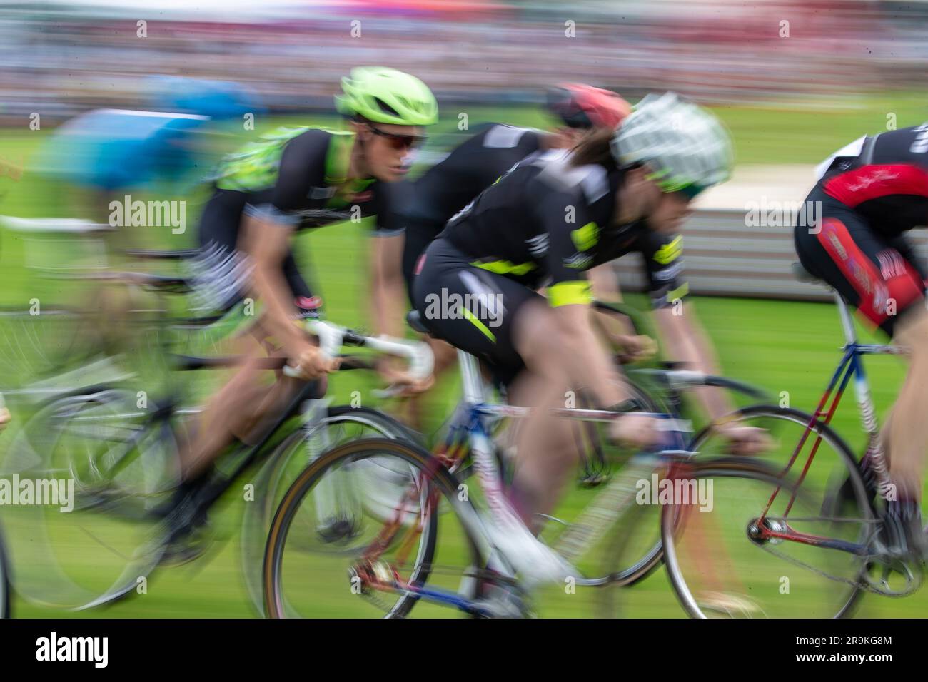 Motion blur as Elite cyclists compete in the bicycle circuit race at the annual Halkirk Highland games in Caithness, Scotland Stock Photo