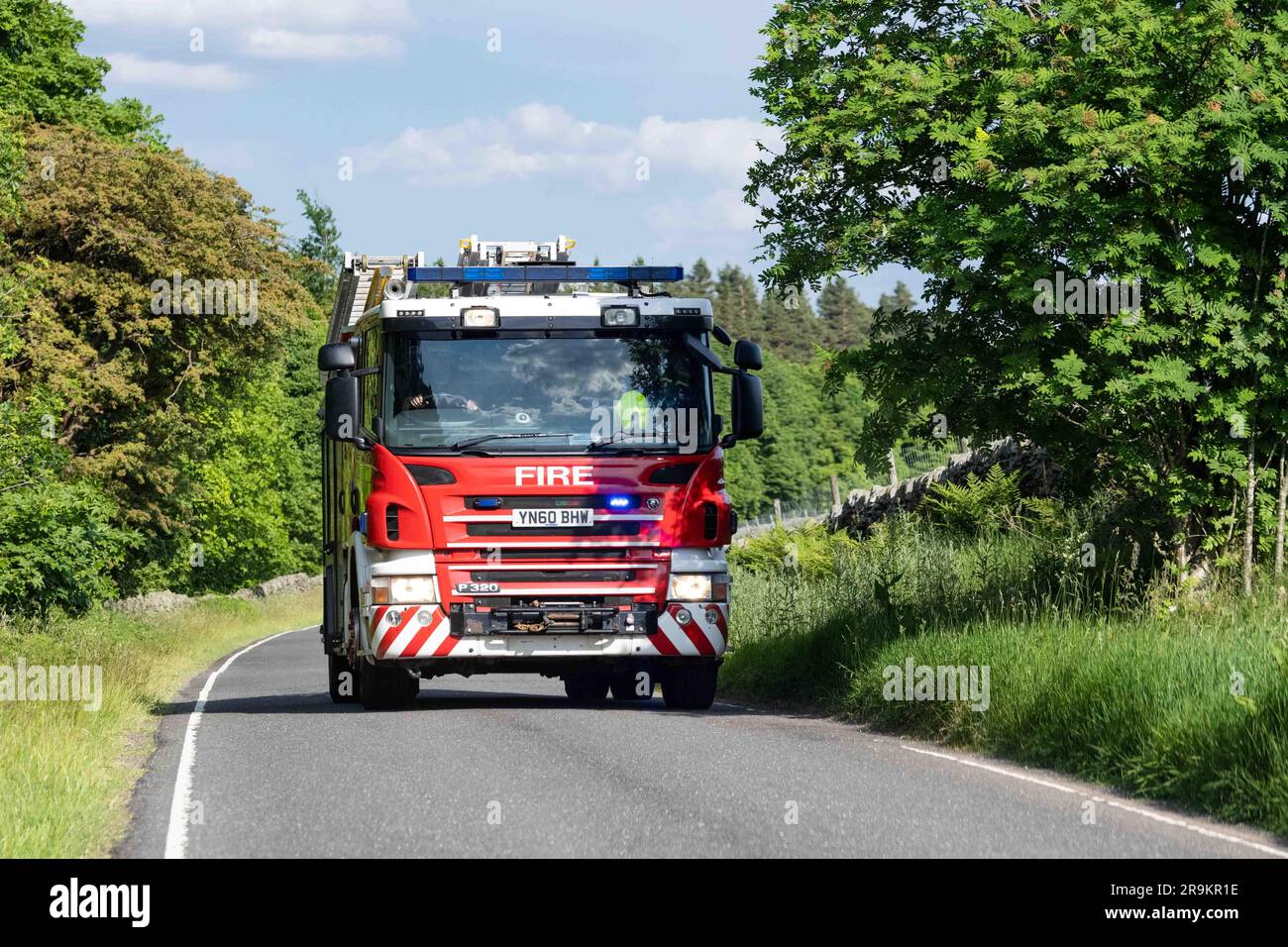South Yorkshire Fire and Rescue fire engine with flashing blue lights - emergency call out to a wildfire near Langsett Reservoir, Sheffield, Yorkshire Stock Photo