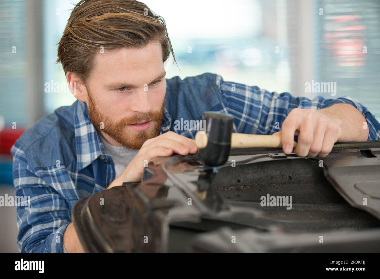 car body-shop worker working with a hammer Stock Photo