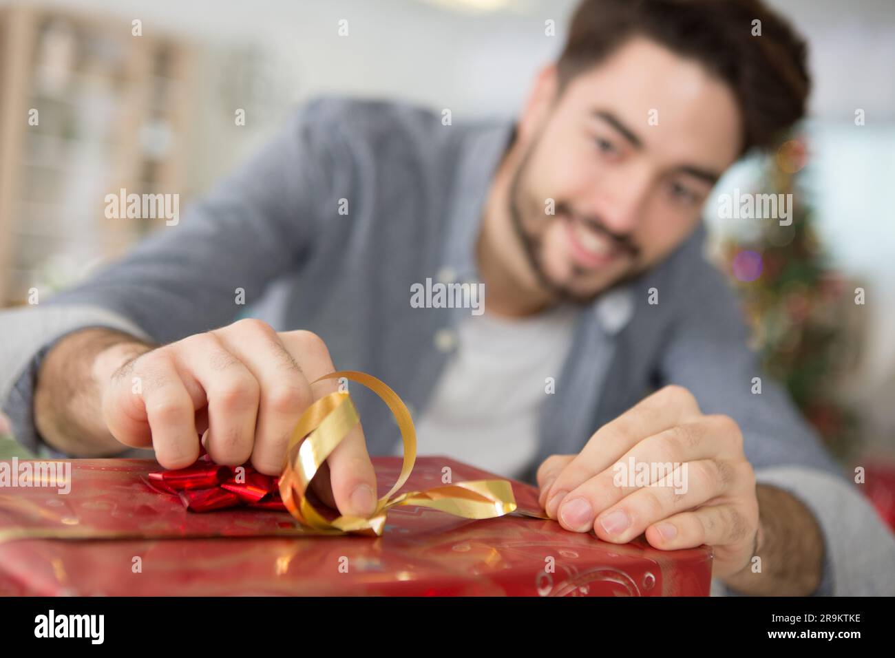 happy man under christmas tree with presents Stock Photo
