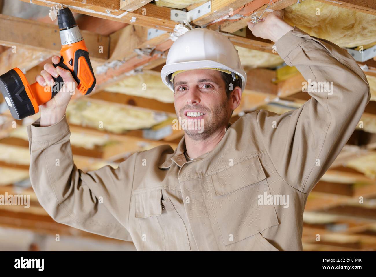 men are drilling the ceiling Stock Photo