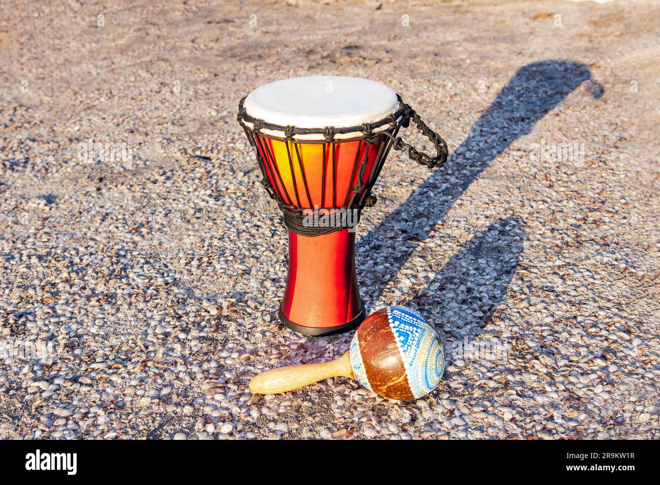 African percussion instrument djembe and marocas on the sand near the