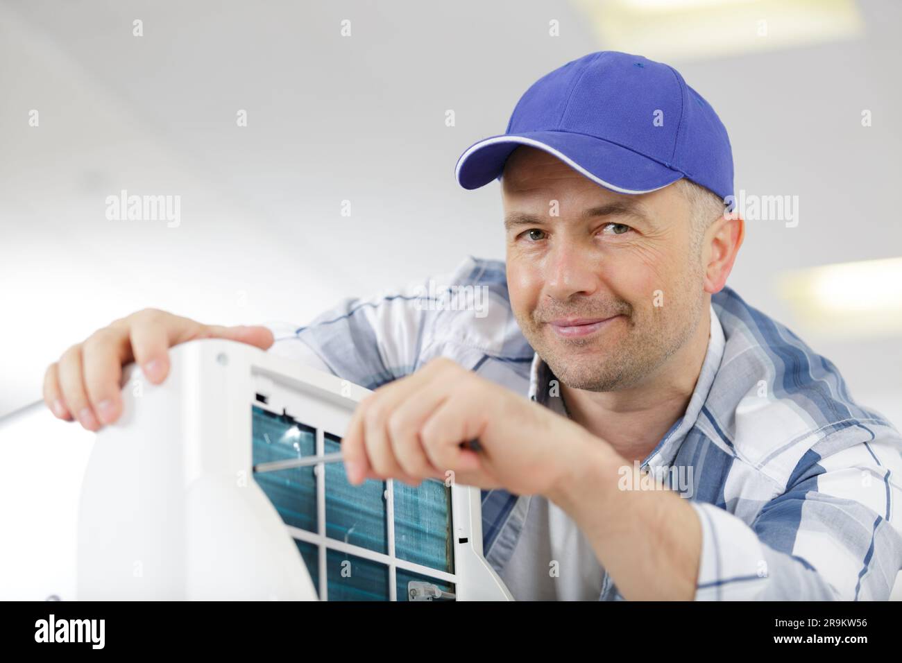 man assembling air conditioning unit Stock Photo Alamy