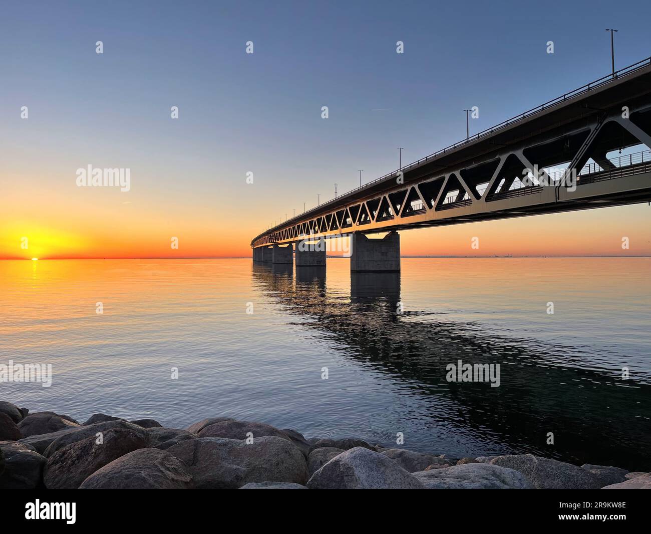 Beautiful sunset on the shores of the Baltic Sea near the Øresund Bridge. Oresund Bridge tunnel between Sweden and Denmark at sunset from Malmö. Moder Stock Photo