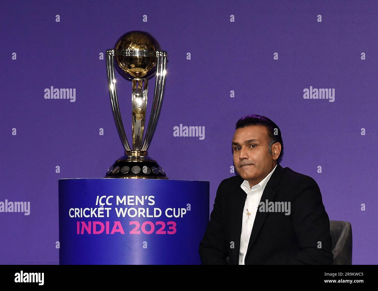 Mumbai, India. 27th June, 2023. Former Indian cricketer Virender Sehwag is seen sitting next to the world cup trophy during the match schedule announcement press conference of men's cricket world cup 2023 in Mumbai. India will be hosting the men's cricket world cup beginning from 5th October 2023. (Photo by Ashish Vaishnav/SOPA Images/Sipa USA) Credit: Sipa USA/Alamy Live News Stock Photo