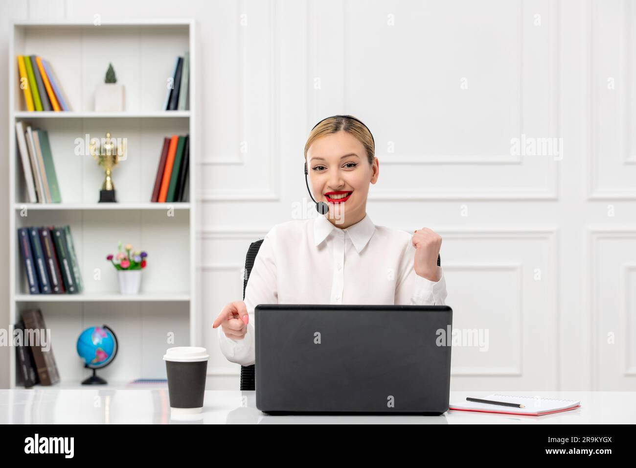customer service cute blonde girl office shirt with headset and computer holding fists up Stock Photo