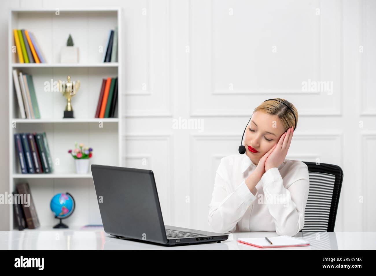 customer service cute blonde girl office shirt with headset and computer tired making sleep sign Stock Photo