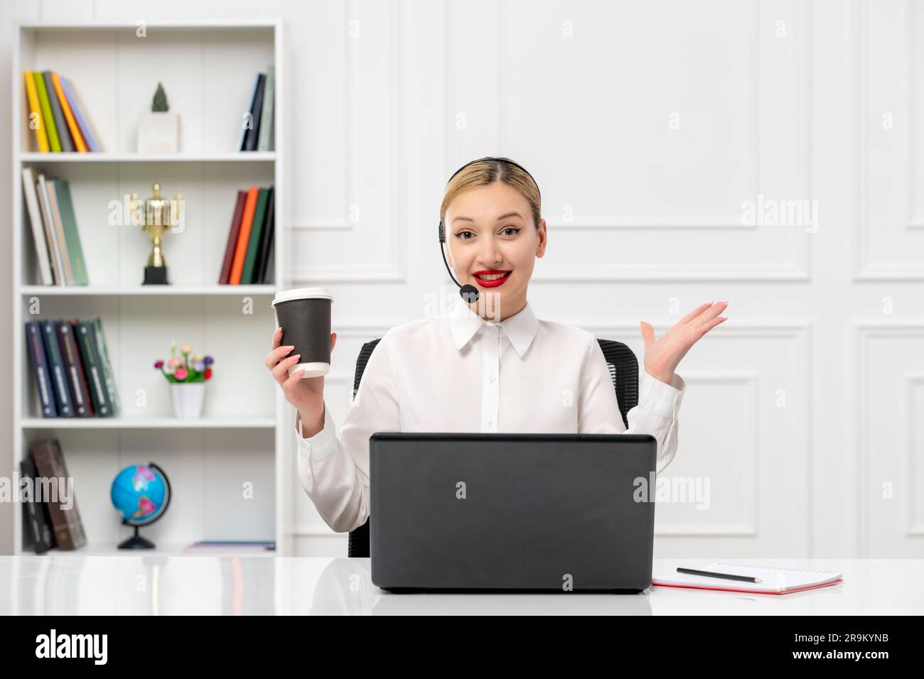 customer service cute blonde girl office shirt with headset and computer waving hands and smiling Stock Photo