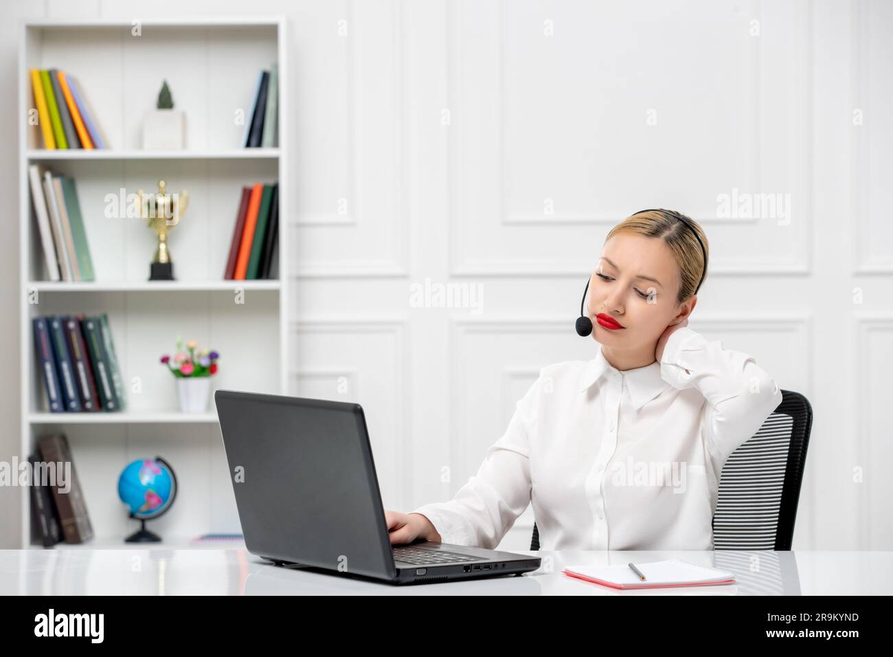 customer service cute blonde girl office shirt with headset and computer typing Stock Photo