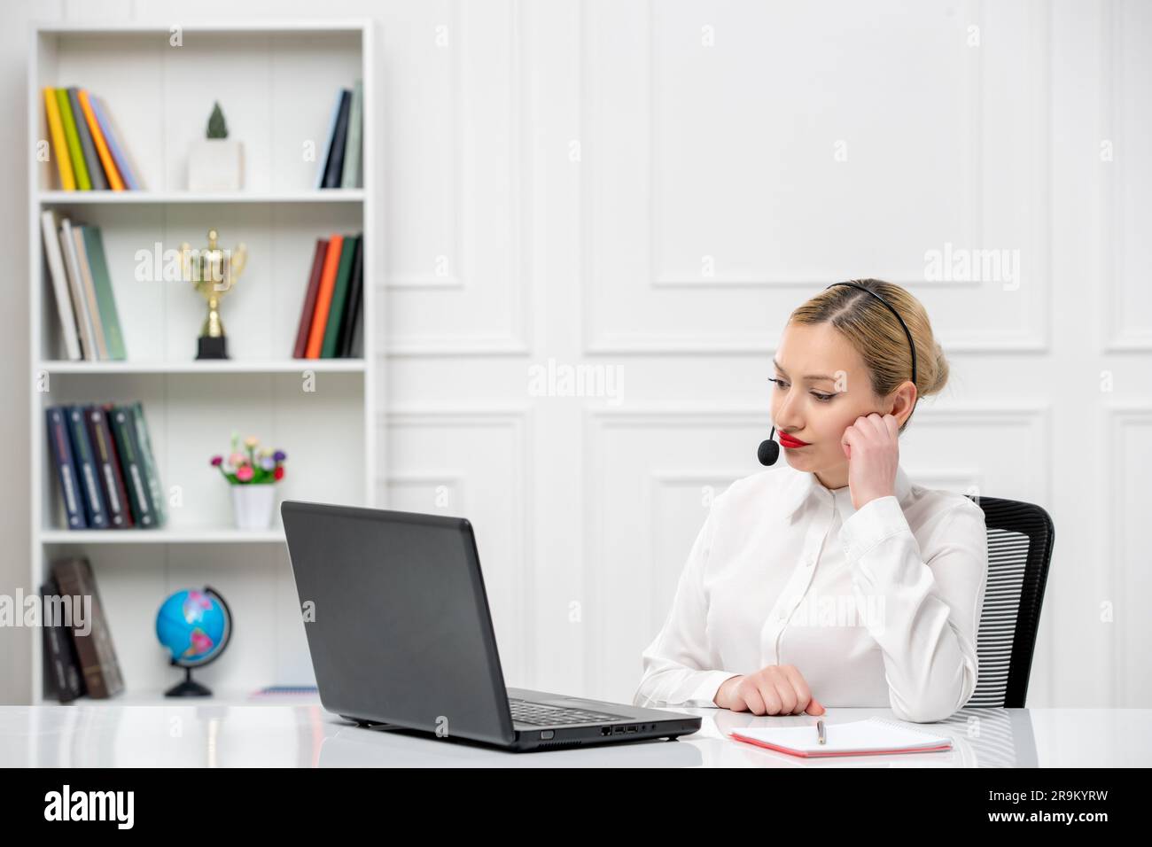 customer service cute blonde girl office shirt with headset and computer thinking Stock Photo