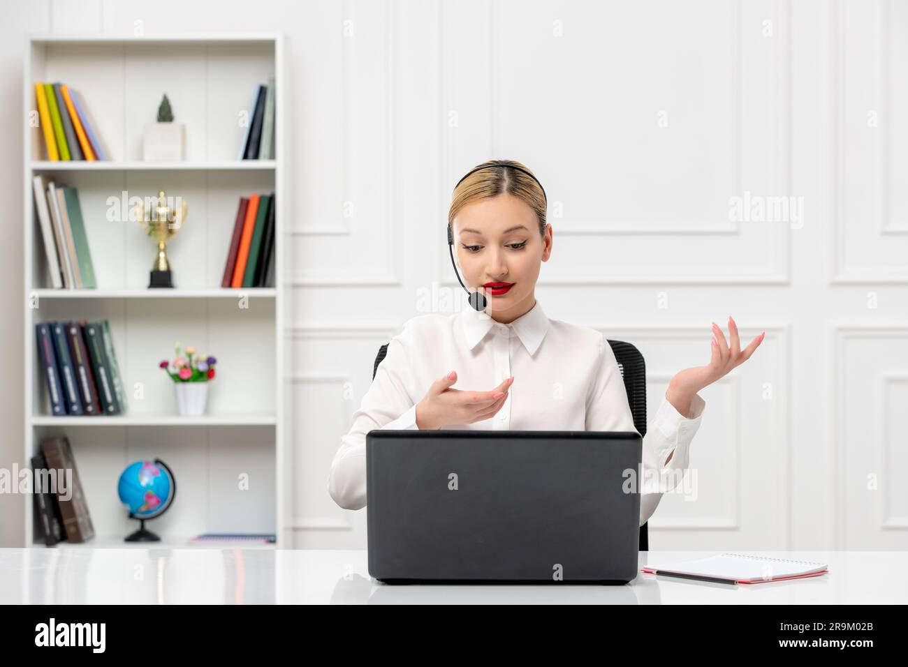customer service cute woman in white shirt with headset and computer talking and waving hands Stock Photo