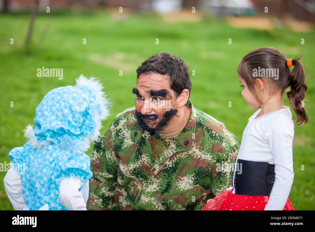 Young father wearing a woodcutter costume playing with his daughters