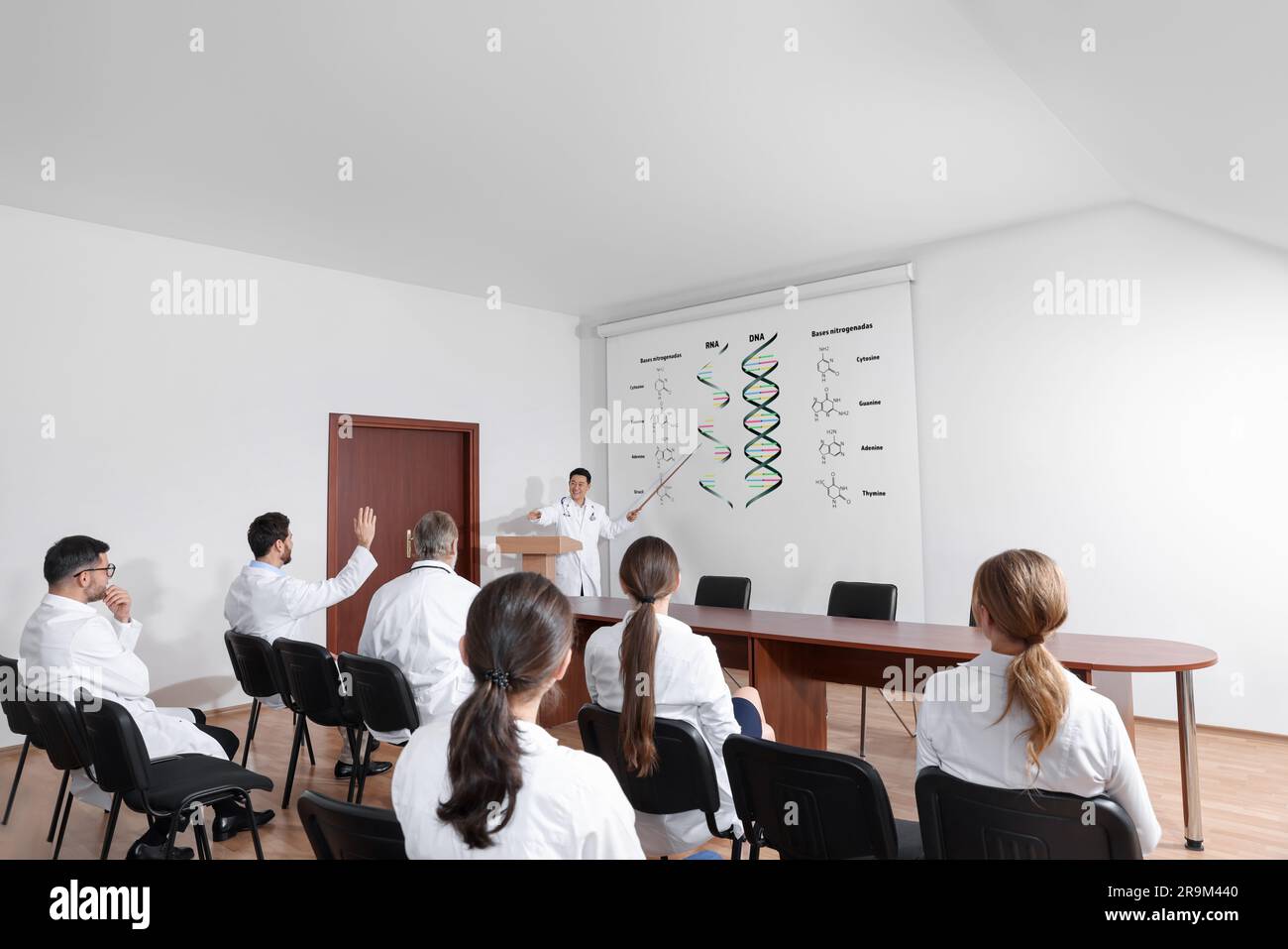 Lecture about difference between RNA and DNA. Professor using projection screen with