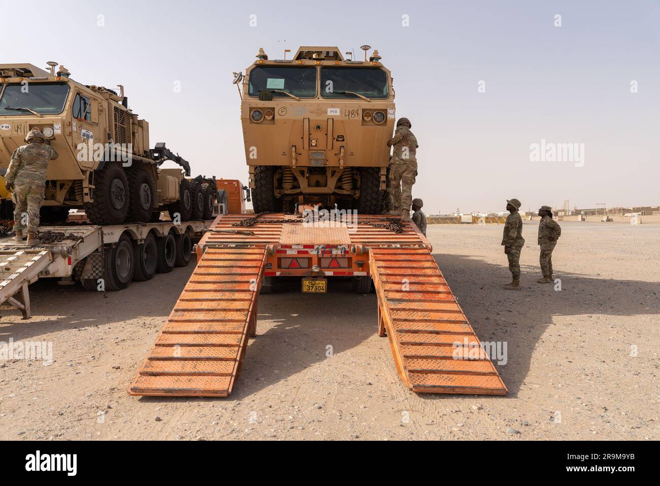 U.S. Army autonomous vehicle, palletized load system, is unloaded by Soldiers assigned to Charlie Company 142nd Division Sustainment Support Battalion, Task Force Legion, at Camp Buehring in Kuwait on June 26, 2023. The U.S. Central Command and U.S. Army Central are leading the way in innovation with autonomous vehicles, enabling the integration of emerging technologies. Task Force Legion is the name of the 382nd Combat Sustainment Support Battalion, in theater, under the 369th Sustainment  Brigade, Task Force Hellfighter. (U.S. Army National Guard video by Staff Sgt. Sebastian Rothwyn) Stock Photo