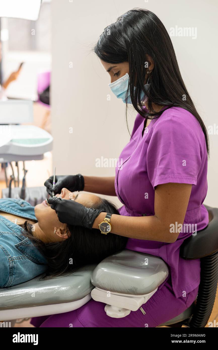 diagnosis with dental team and healthcare professional working, dentist performing oral