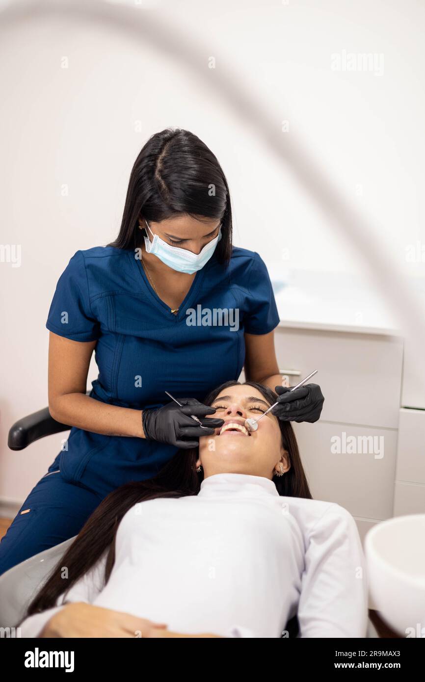 young patient with open mouth being examined, dentist work day, medicine and oral health in office interior Stock Photo