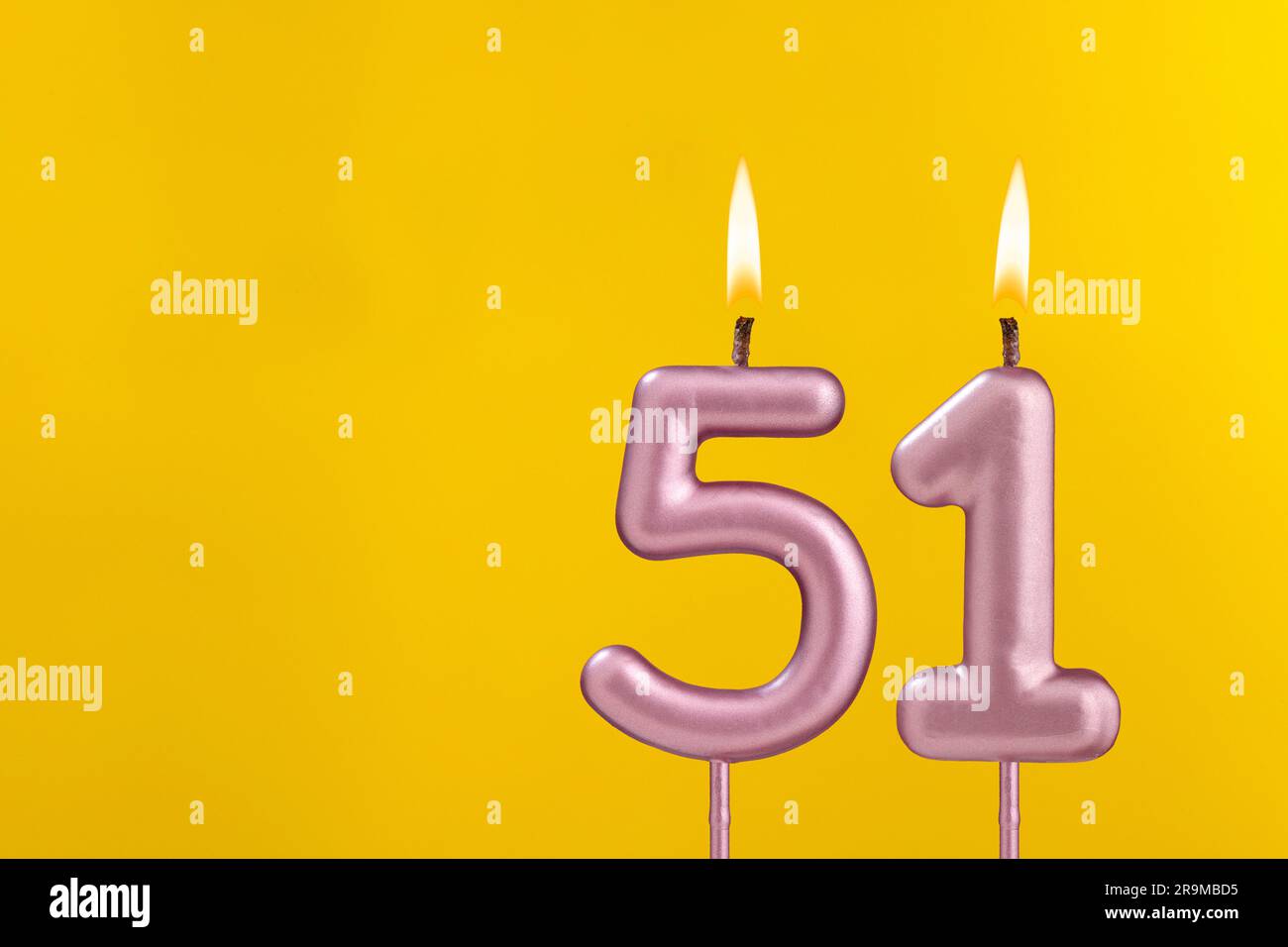 Birthday candle number 51 - Birthday celebration on yellow background