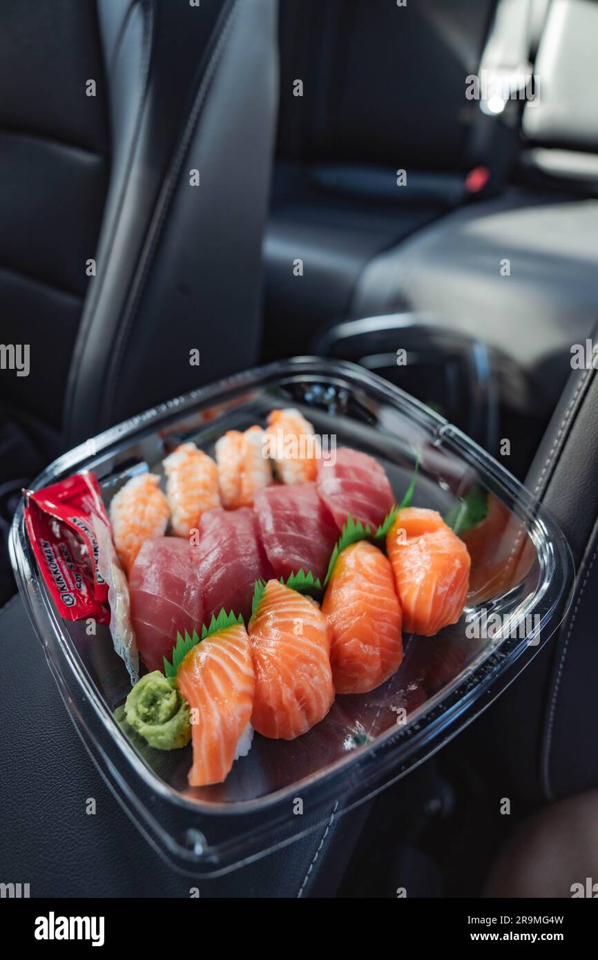 A customer's plate filled with a selection of Costco sushi takes center