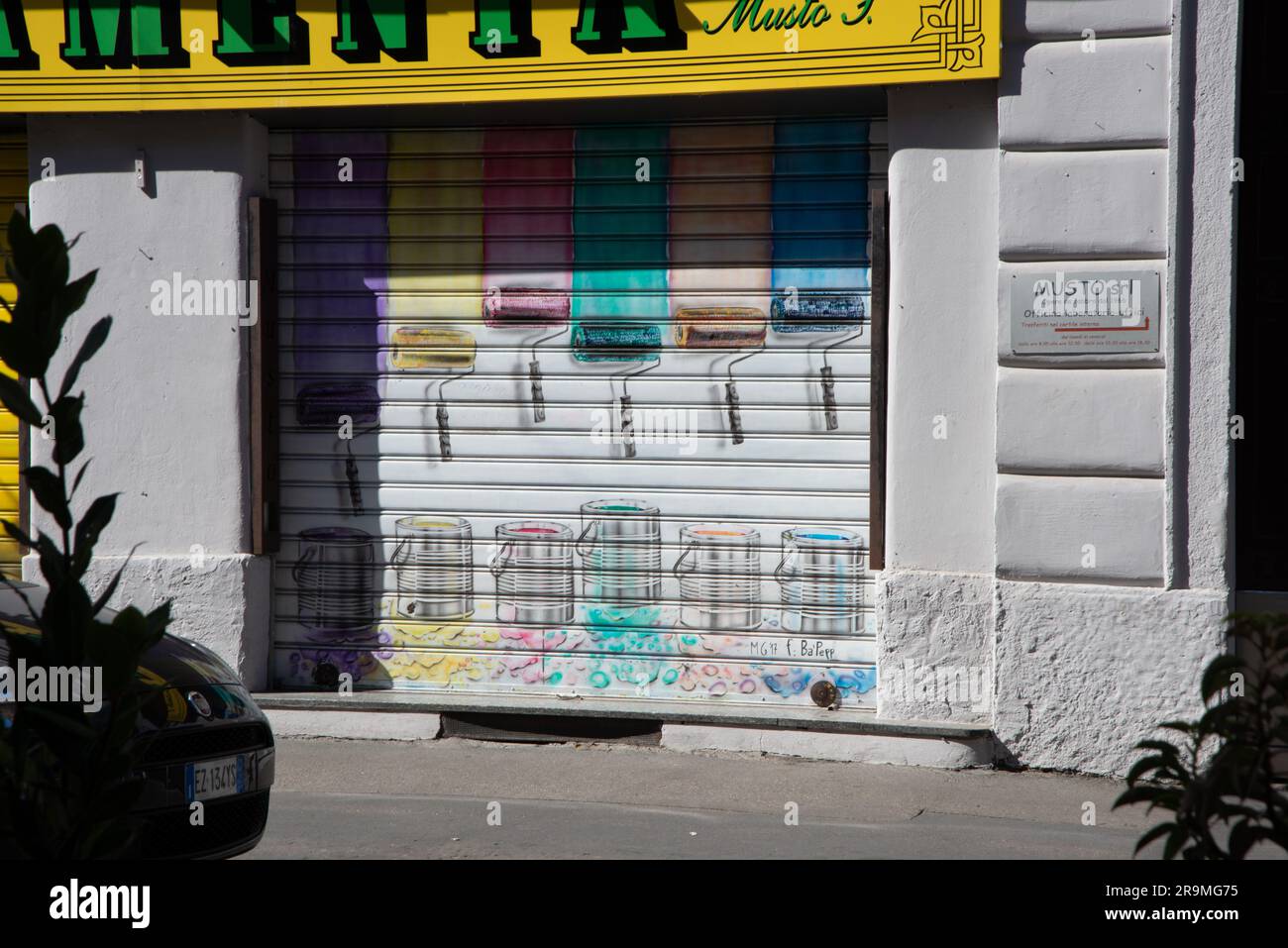 Milan, Italy store shutter paint roller artwork Stock Photo