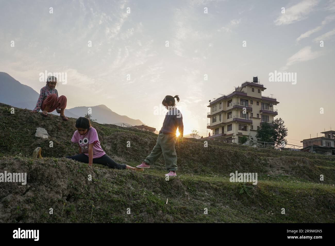 Girls play at sunset in Kathmandu, Bagmati province, Nepal on March 28, 2023. (Sunita Neupane/Global Press Journal) Stock Photo