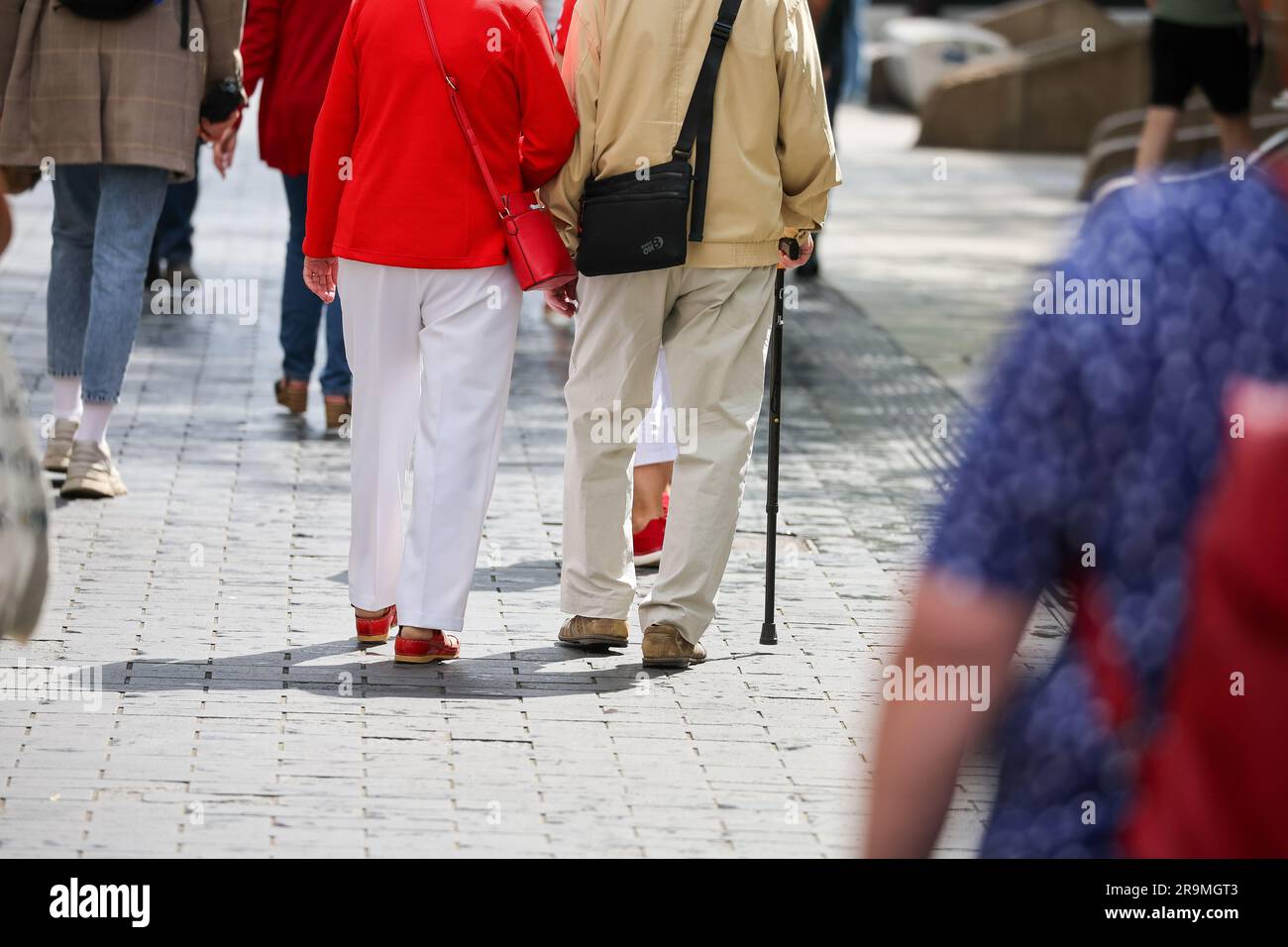 Leipzig, Germany. 27th June, 2023. A senior citizen couple walks through downtown Leipzig. The approximately 21 million pensioners in the country will receive more money starting in July. With the annual pension adjustment, old-age pensions will rise by 4.39 percent in the west and 5.86 percent in the east. In addition, almost 30 years after reunification, the so-called pension value in the east will be brought into line with that in the west - one year earlier than planned. Credit: Jan Woitas/dpa/Alamy Live News Stock Photo
