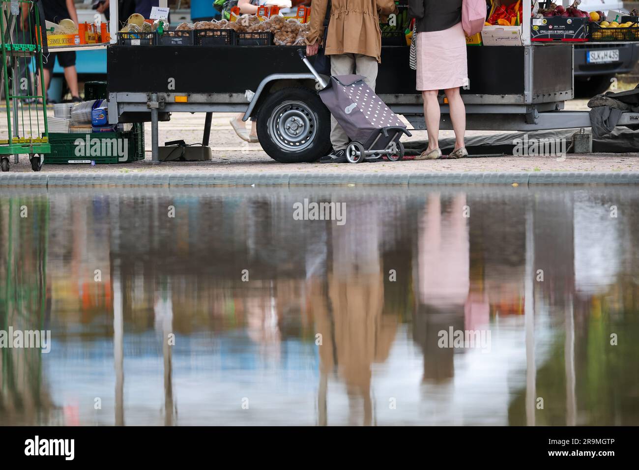 Leipzig, Germany. 27th June, 2023. A senior couple stands at the weekly market in downtown Leipzig. The approximately 21 million pensioners in the country will receive more money starting in July. With the annual pension adjustment, retirement benefits will rise by 4.39 percent in the west and 5.86 percent in the east. In addition, almost 30 years after reunification, the so-called pension value in the east will be brought into line with that in the west - one year earlier than planned. Credit: Jan Woitas/dpa/Alamy Live News Stock Photo