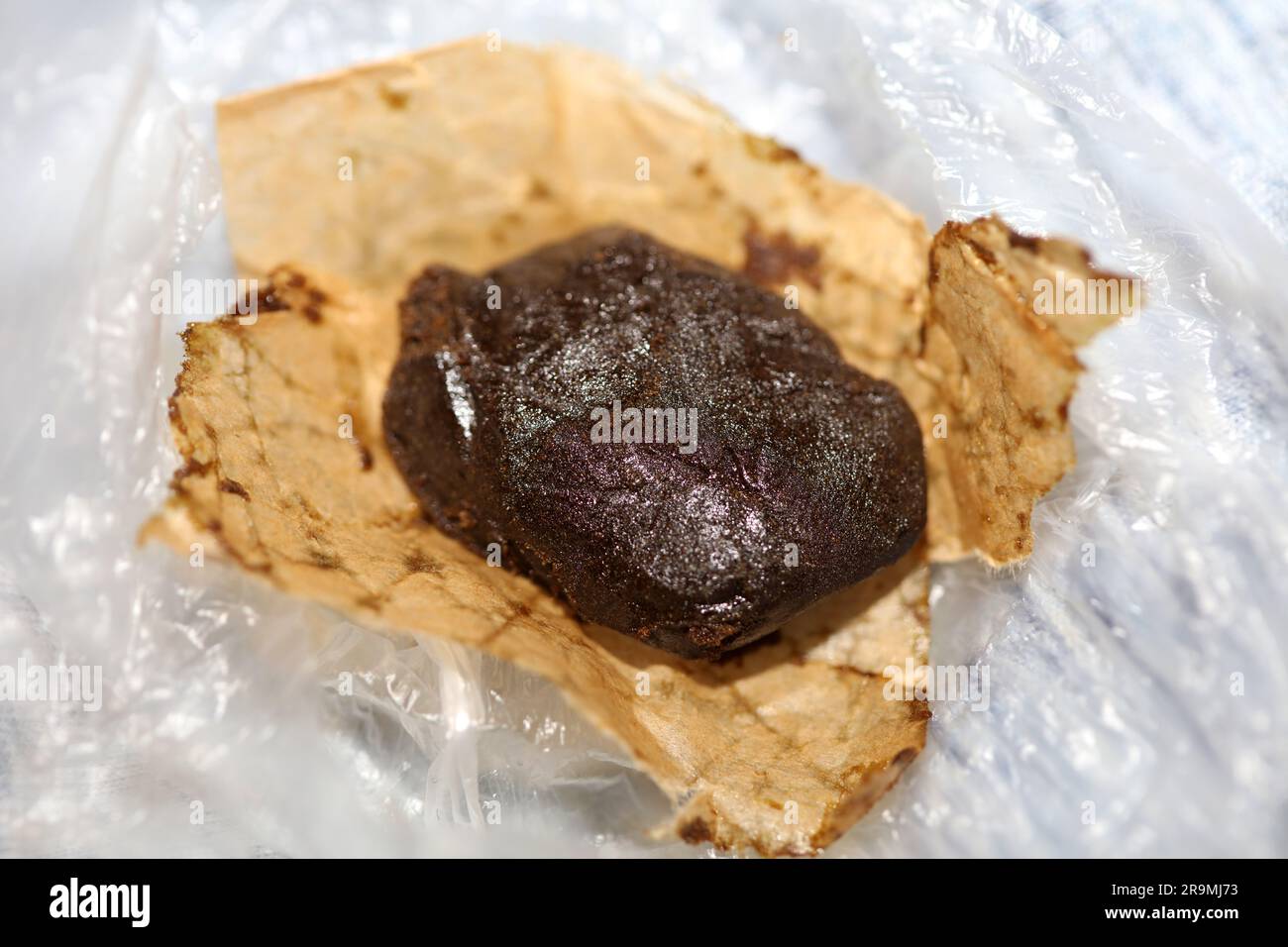 Detail of medical marijuana nepalese high thc brown charas close up bio cannabis resin hashish in Nepal extraction dry hash pollen big size amazing qu Stock Photo