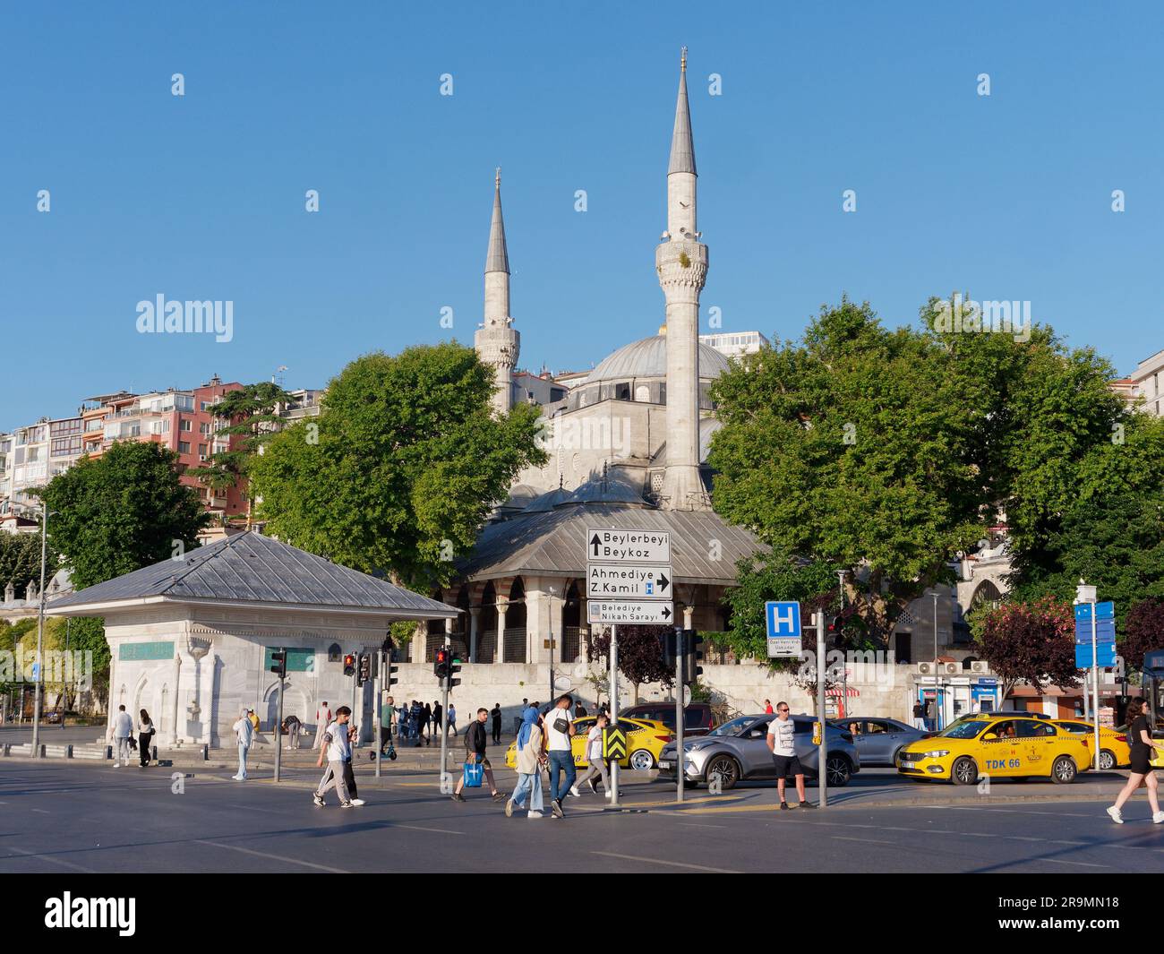 Trafiic waits at a junction in Uskudar with the  Mihrimah Sultan Mosque behind, Istanbul Turkey Stock Photo