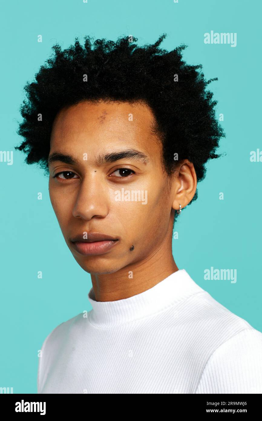 Close-up portrait serious young black man looking at camera Stock Photo