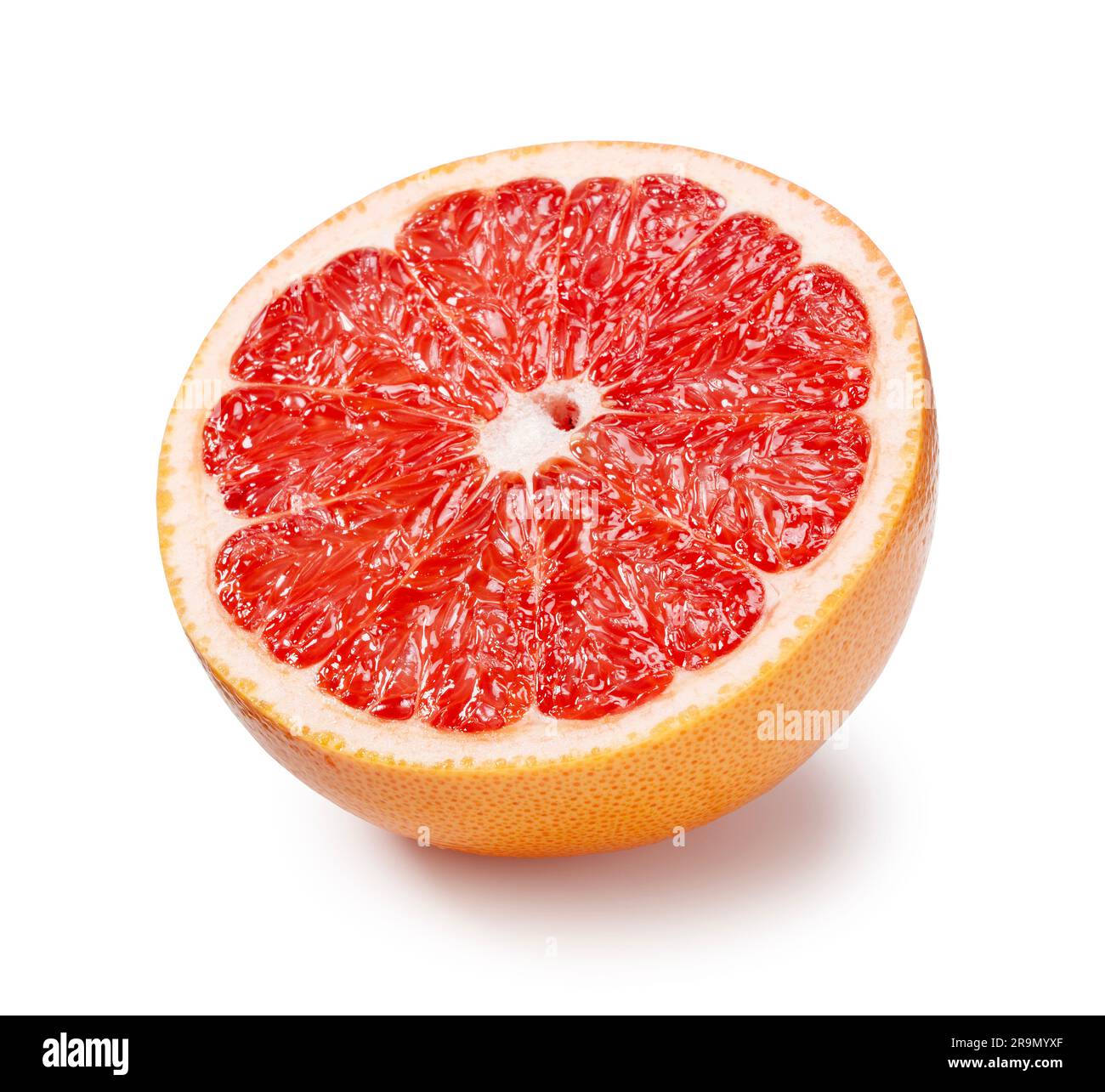 A grapefruit cut in half placed on a white background. Stock Photo