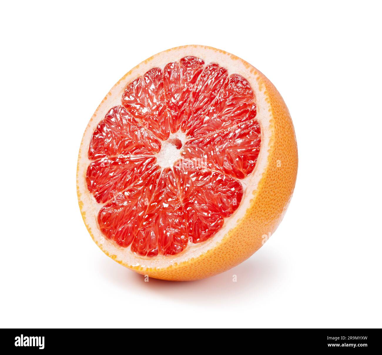 A grapefruit cut in half placed on a white background. Stock Photo
