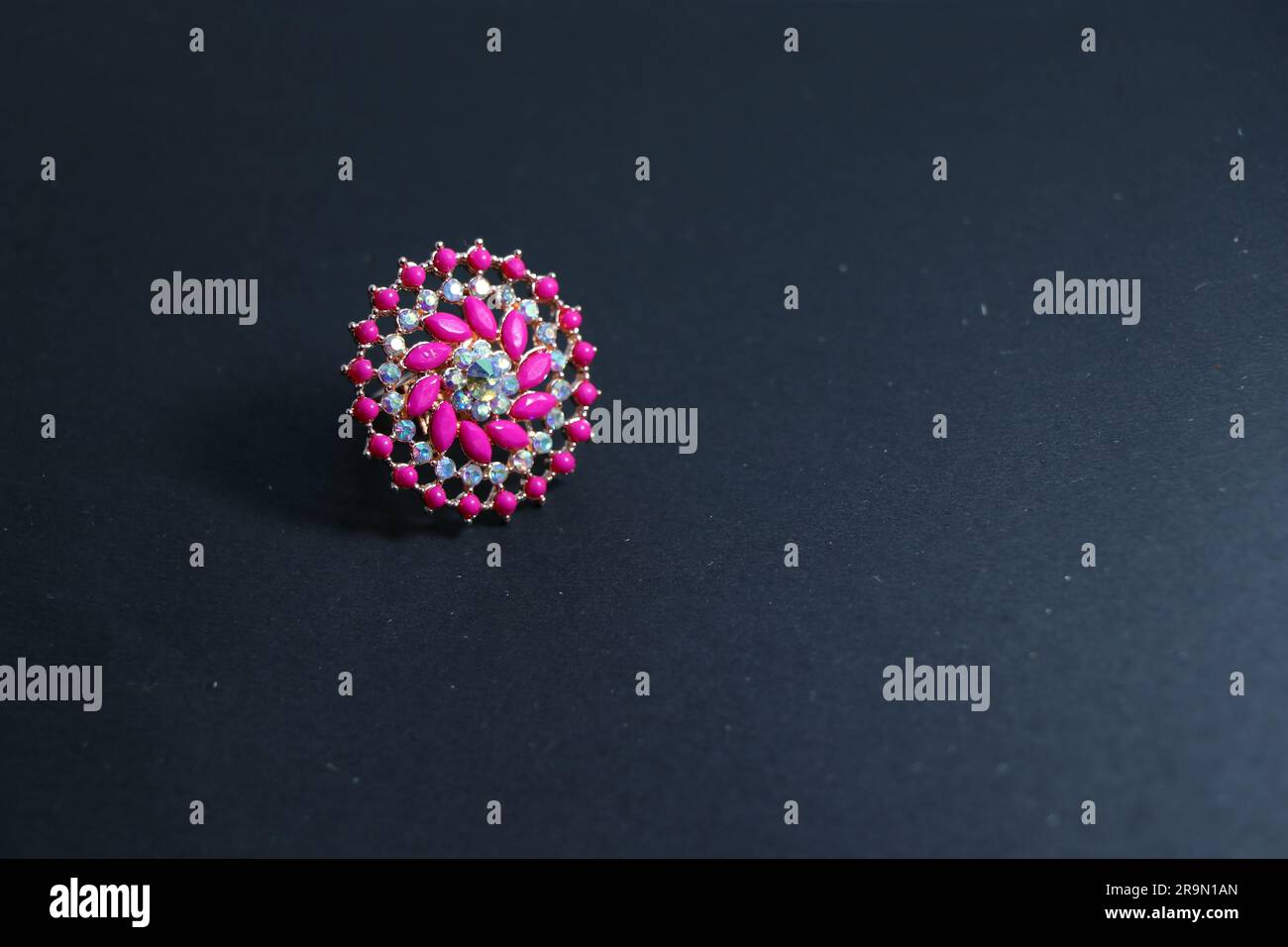 Elegance Refined: Pink Stone Silver Ring on a Black Canvas - A Captivating Stock Image for Online Delights! Stock Photo