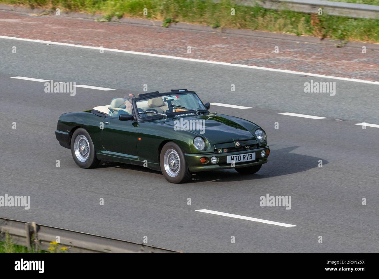 1994 90s nineties Woodcote green MG RV8 V8 British sports Car Rover V8 engine 4000 cc; travelling at speed on the M6 motorway in Greater Manchester, UK Stock Photo