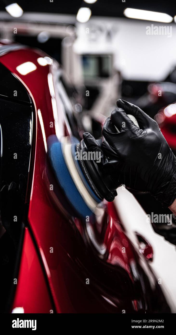 Electric machine paint correction in a car detailing studio Stock Photo Alamy