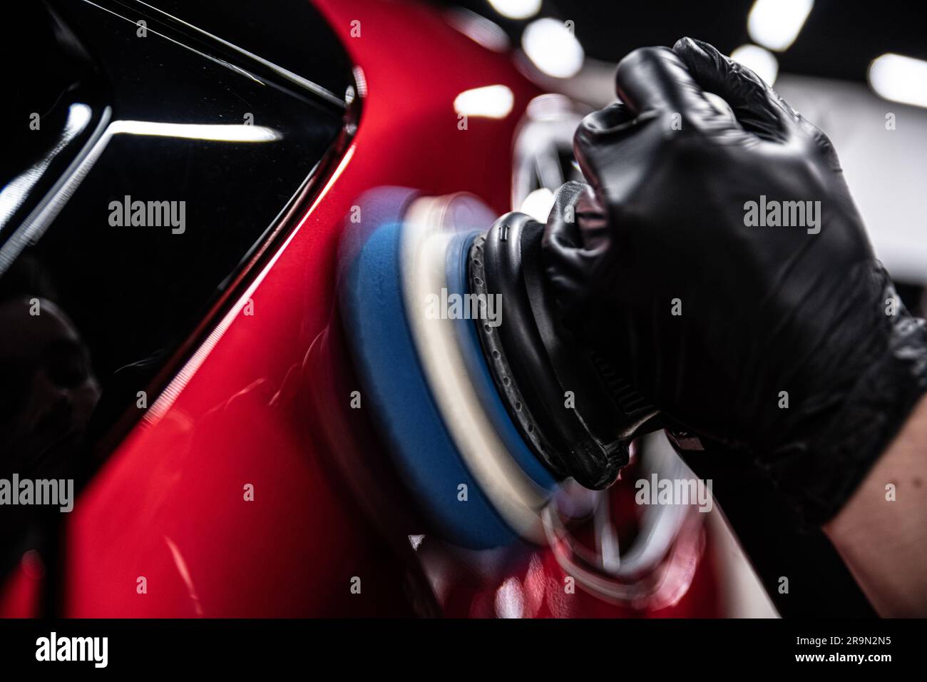 Electric machine paint correction in a car detailing studio Stock Photo Alamy