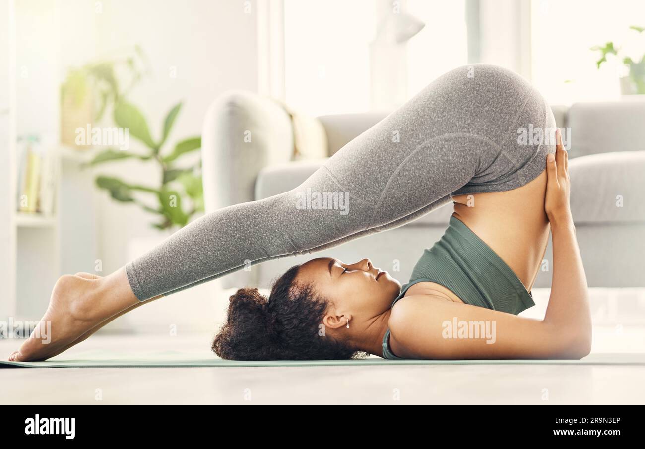 Yoga, woman and zen in living room with stretching and meditation feeling calm on gym mat. Wellness, relax and female person with spiritual exercise Stock Photo